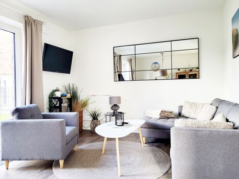 Wohnbereich mit TV Ferienhaus Paul