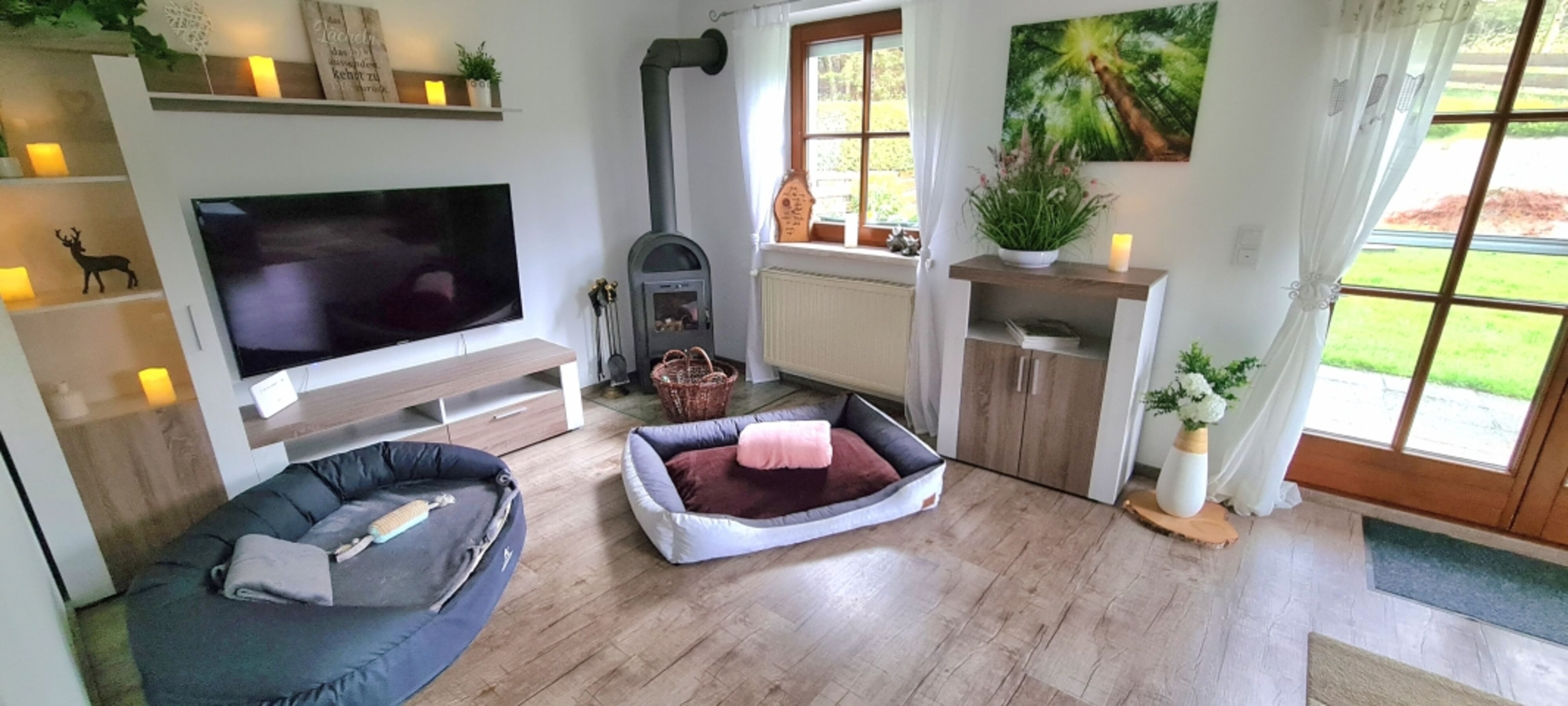 Wohnzimmer mit L-Lounge Couch // 55 Zoll Smart TV // Kaminofen // große Terrassentür zum Garten // TOP WLAN