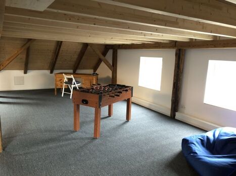 Freizeitbereich mit Kicker, Schreibtisch und LED-TV und WII