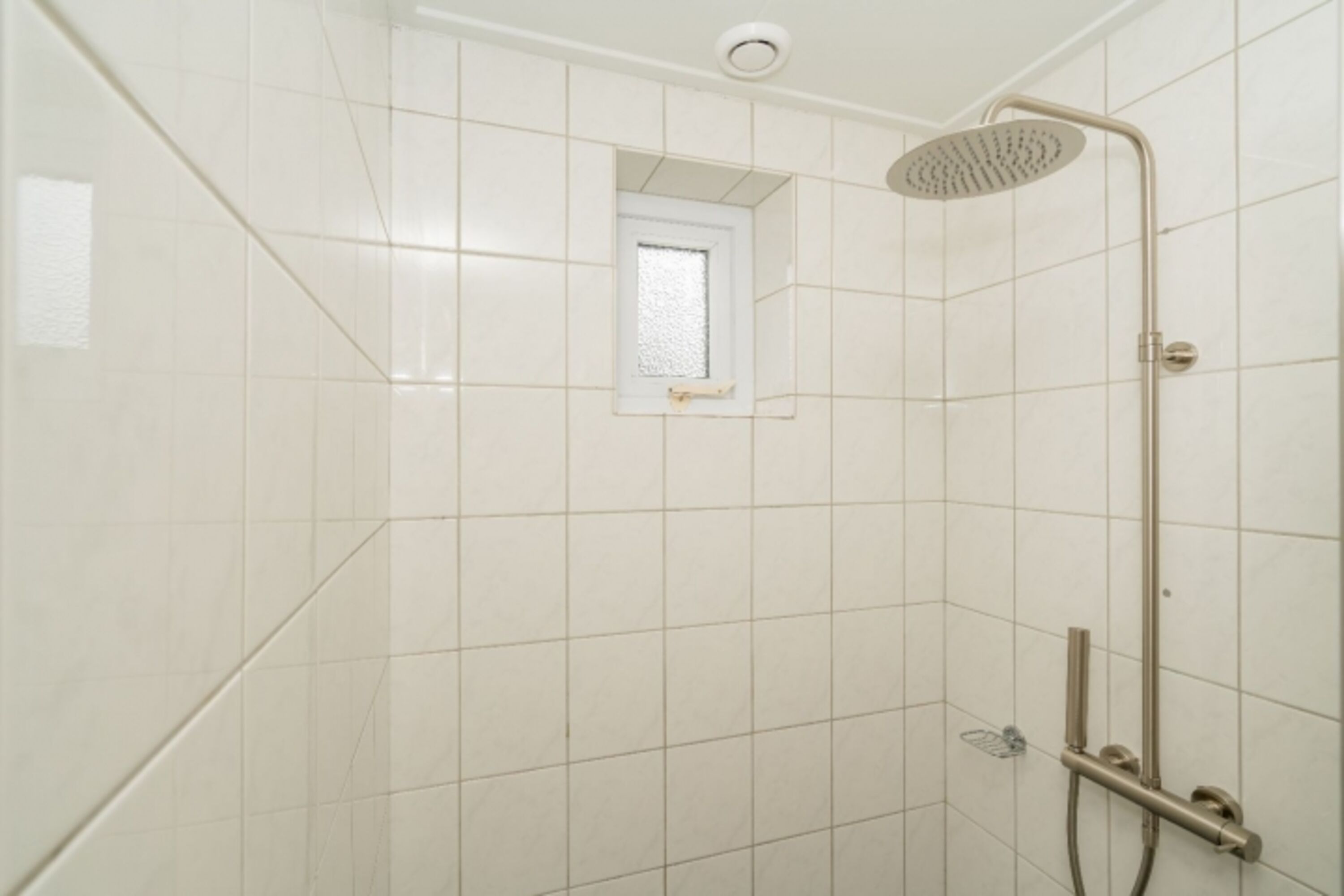 Badezimmer mit Regendusche und Waschbecken