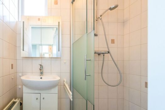 Badezimmer mit Dusche und Waschbecken