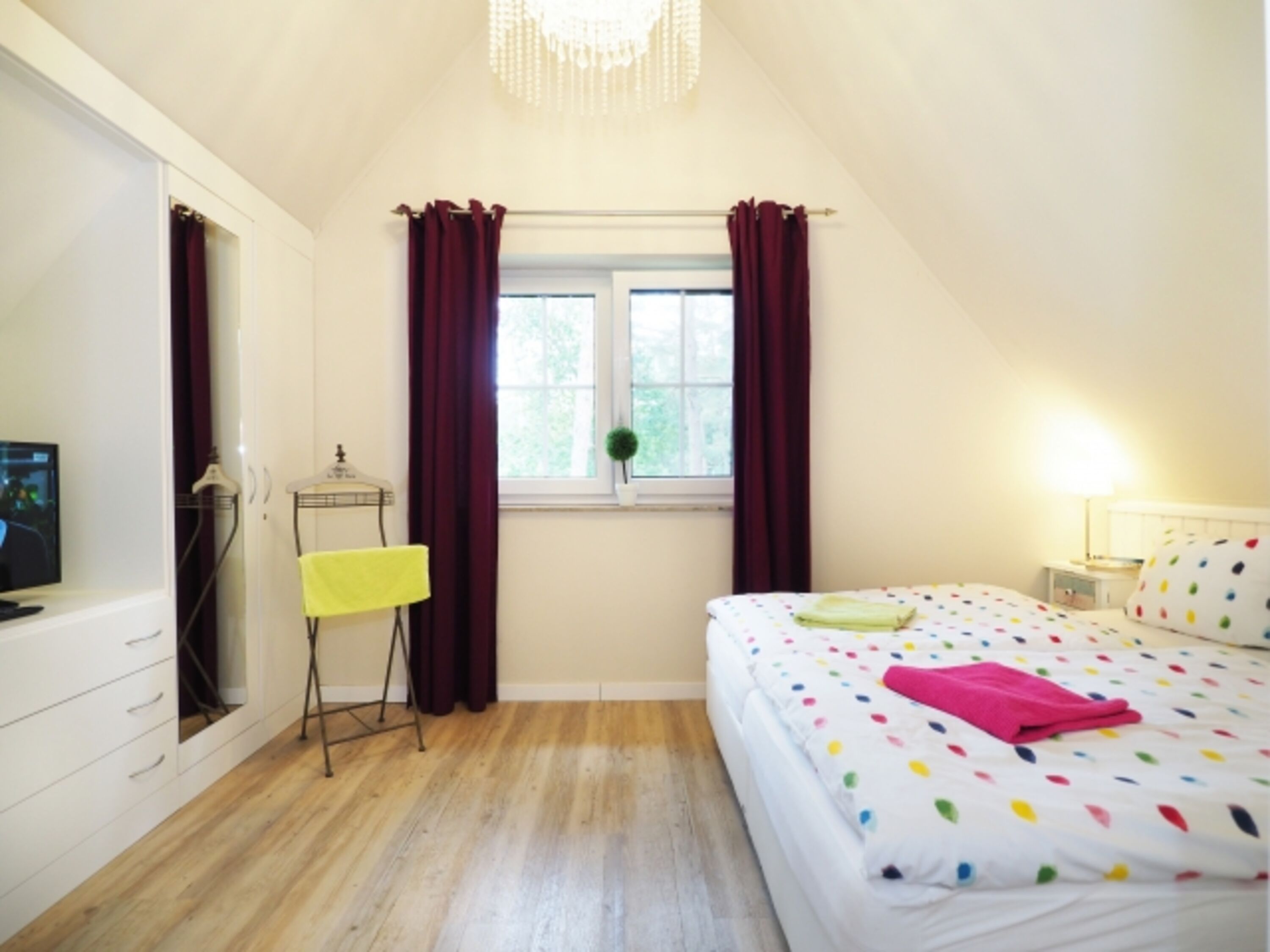 Das Schlafzimmer mit Einbauschränken und TV