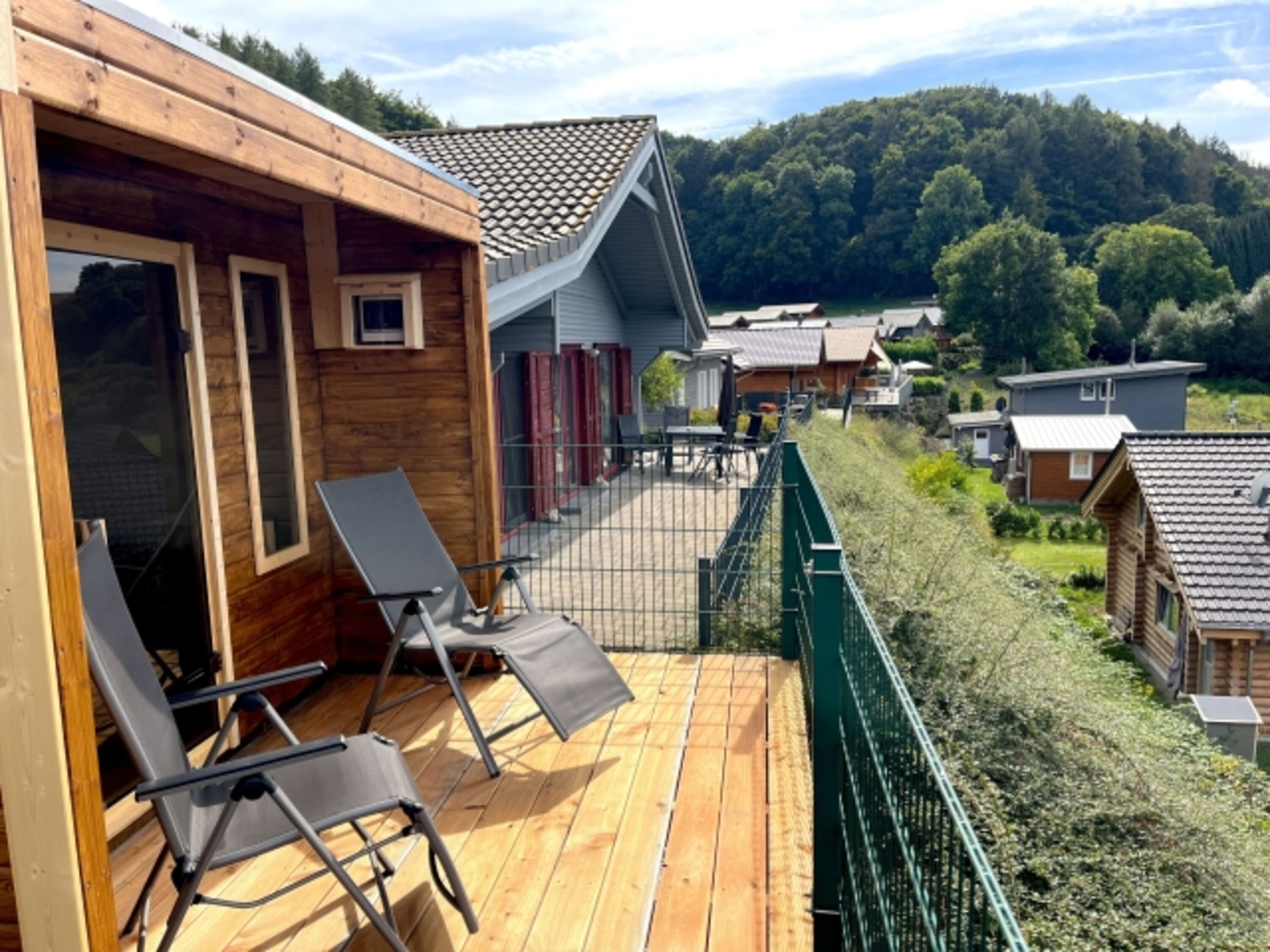 Moderne Außen-Sauna mit schönem, überdachtem Außenbereich und Liegestühlen