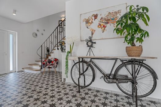 Der Flur ist eine Augenweide: Gemälde, Fahrradskulpturen und Vasen schmücken die Wände und Regale.