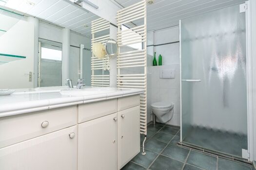 Badezimmer mit Dusche, Waschbecken und Toilette