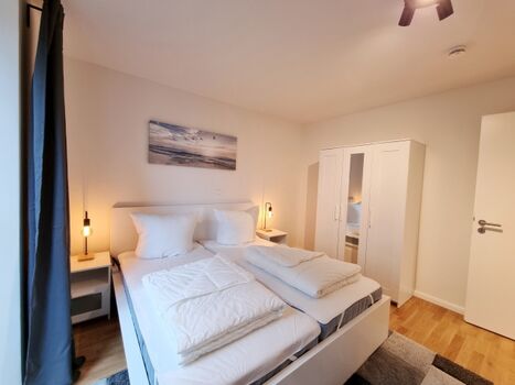 das Doppelbettzimmer mit Fernseher