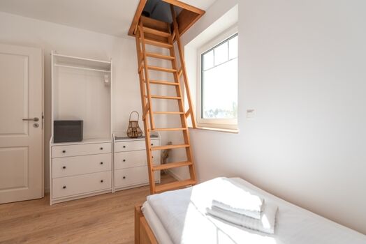 Schlafzimmer 2 im Obergeschoss mit Leiter zum Dachgeschoss