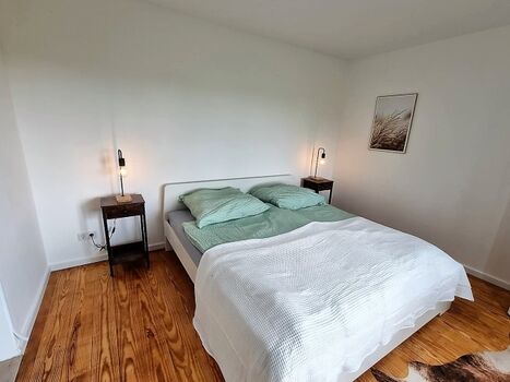 Das erste Schlafzimmer mit gemütlichem Doppelbett...