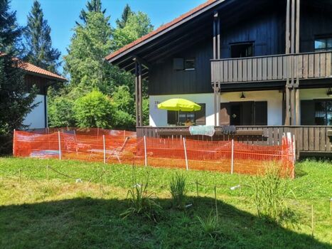 Hausansicht im Sommer mit Zaun