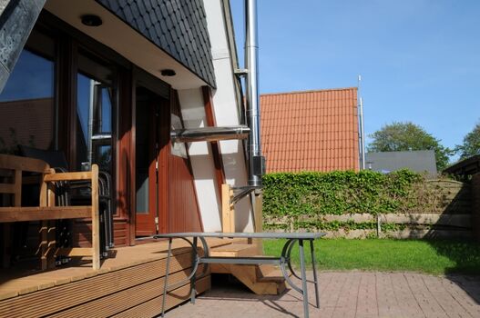 Die Terrasse mit Gartenmöbel und Holzkohlegrill