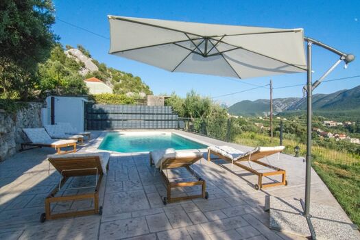 Liegestühle und Sonnenschirm