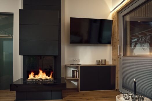 Wohnzimmer mit Kamin und TV