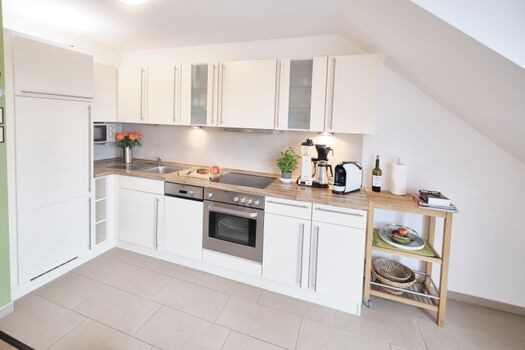 Die vollausgestattete, offene Küche hat alles was das Herz begehrt - zwei Kaffeemaschinen, Backofen, Spülmaschine und als Highlight eine Popcorn Maschine