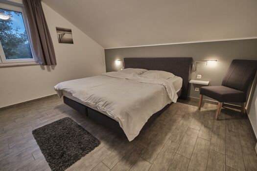 Schlafzimmer 2 mit Boxspring Doppelbett (180x200cm), Kleiderschrank, Safe, Babybett und TV