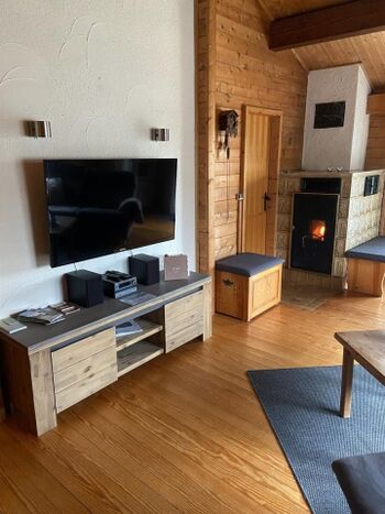 Smart-TV mit dem Kachelofen im Hintergrund