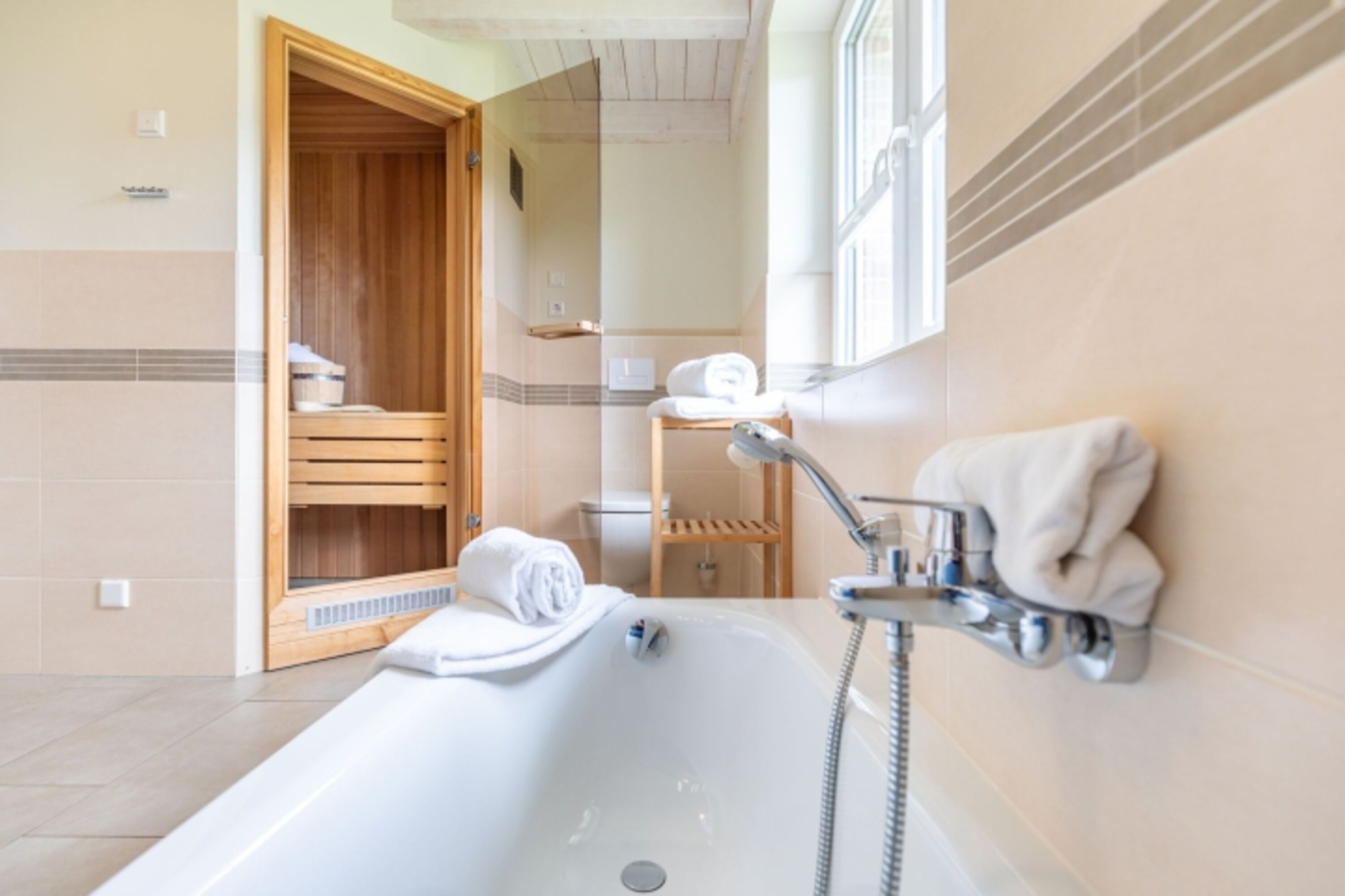 Badezimmer mit Dusche, Wanne und Sauna