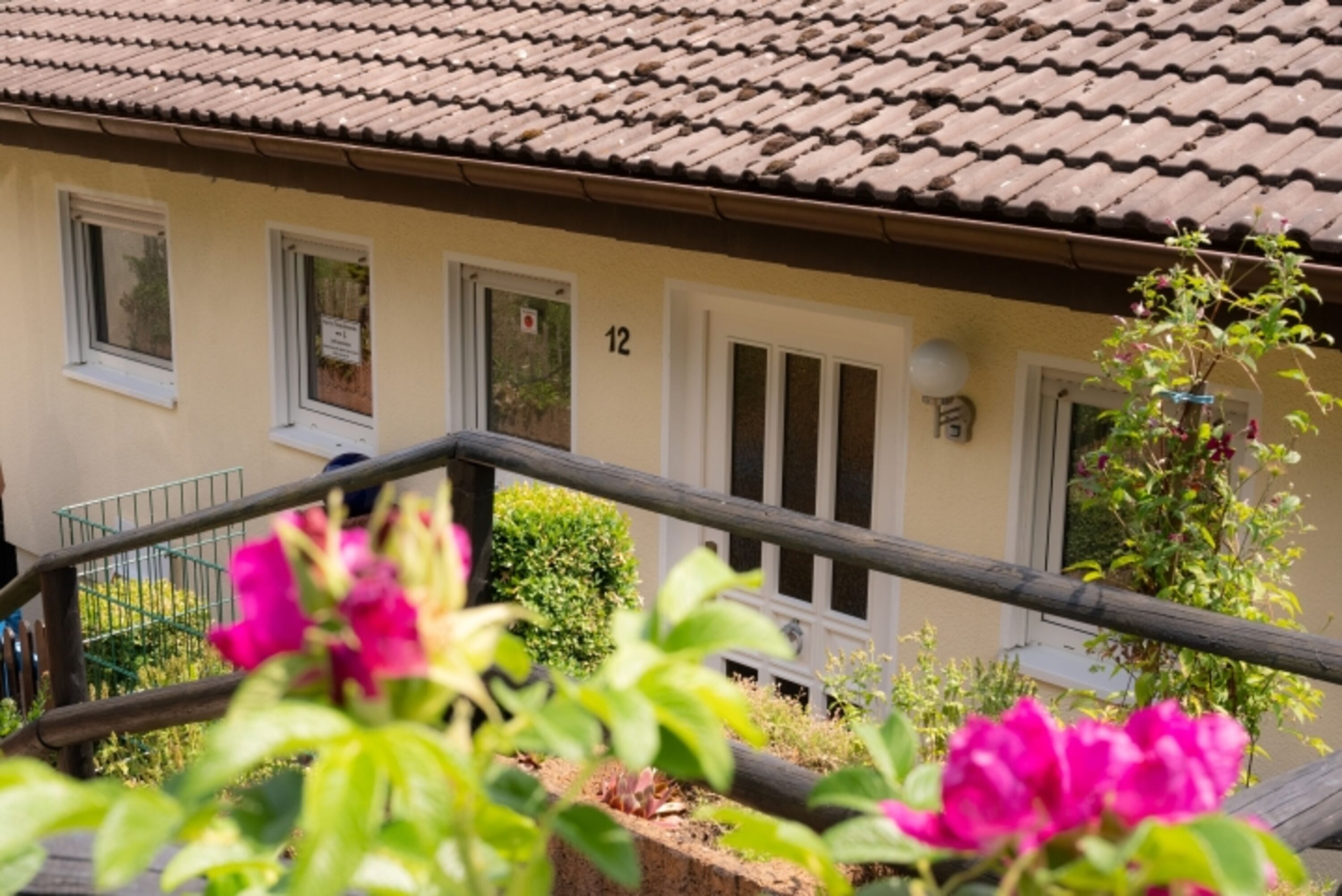 Hauseingang mit Terrasse , Sitzmöglichkeit und Gasgrill