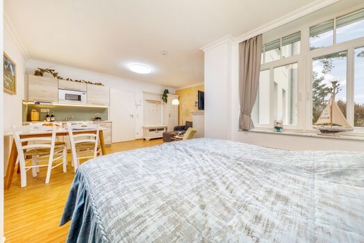 Das Fenster schaut zur Düne, dahinter ist das Meer.