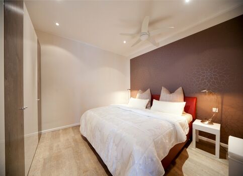 Schlafbereich mit Doppelbett und Kleiderschrank.