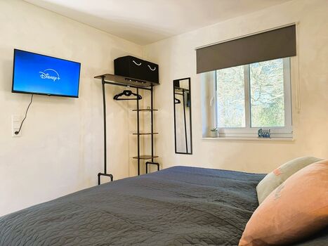 Schlafzimmer mit Doppelbett (180 x 200 cm) und TV