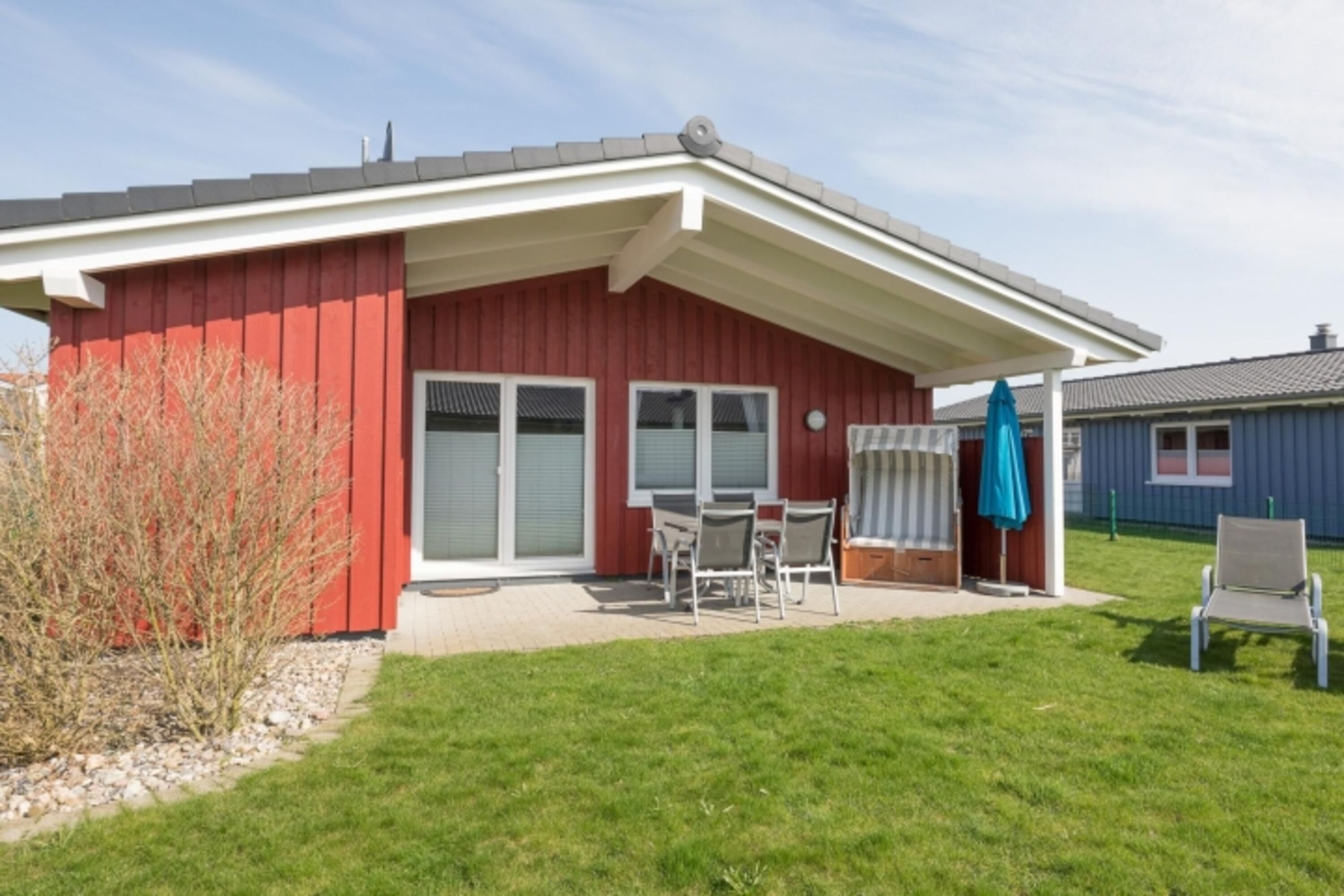 Ferienhaus Hallig Hooge – Sonnige Terrasse mit Strandkorb und Gartenmöbeln