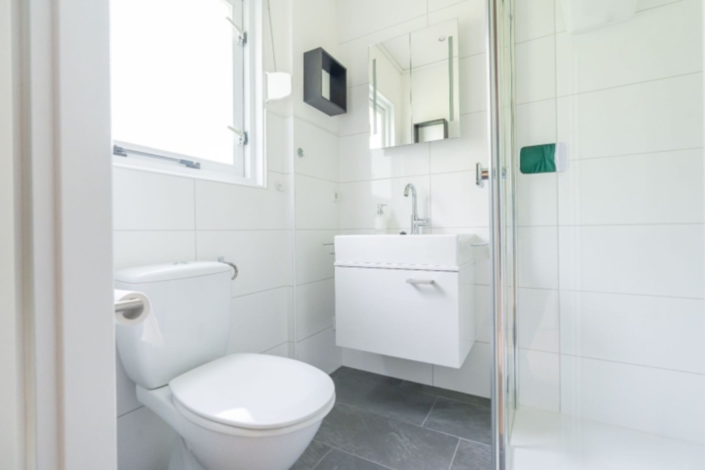 Badezimmer 1 mit Dusche, Waschbecken und Toilette