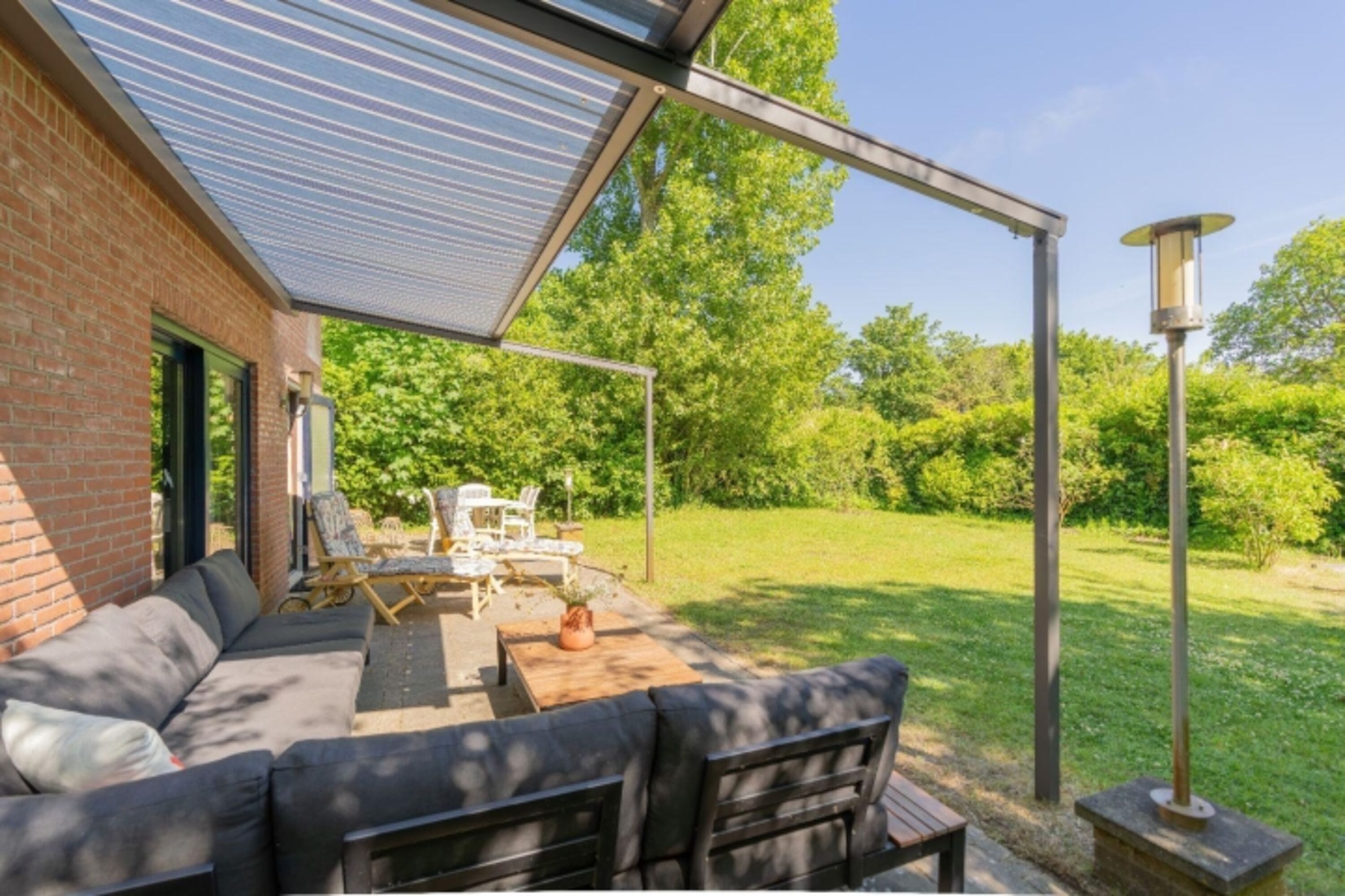 Die sonnige Terrasse mit Gartenmöbel