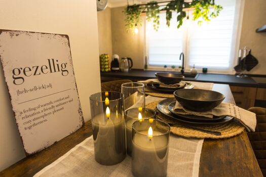 Gemütlichkeit in jedem Detail: Kerzenlicht, rustikale Geschirrfarben und warme Akzente machen diese Bar zum perfekten Ort für lange Abende, gute Gespräche und schöne gemeinsame Momente.