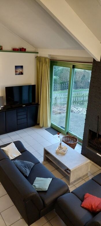 Wohnbereich mit großem Smart TV und Terrassentür