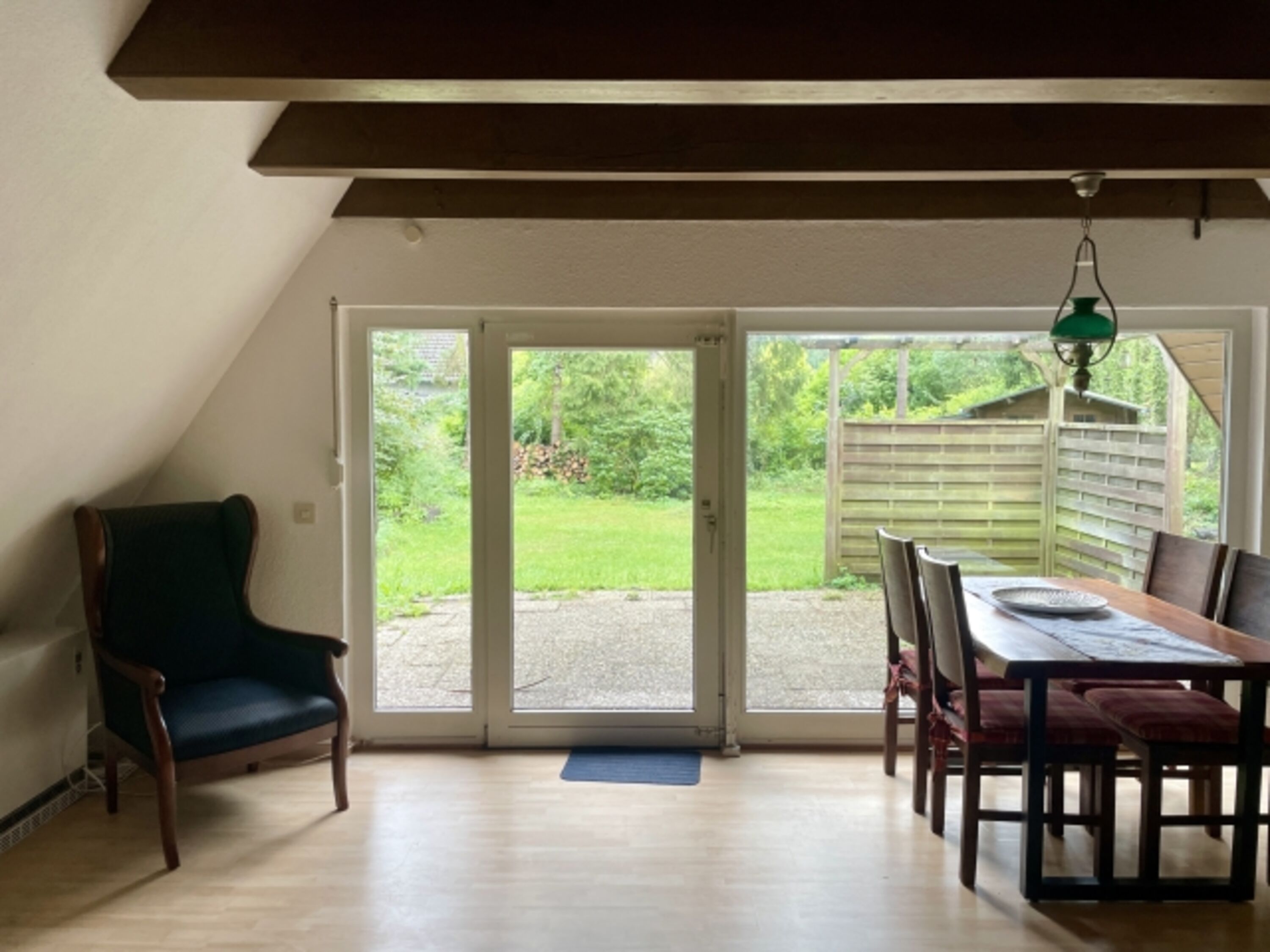 Wohnzimmer mit großer Fensterfront und Gartenblick