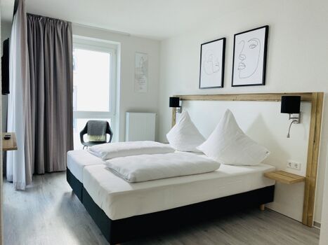 erstes Schlafzimmer mit geräumigen Schränken und Smart TV 