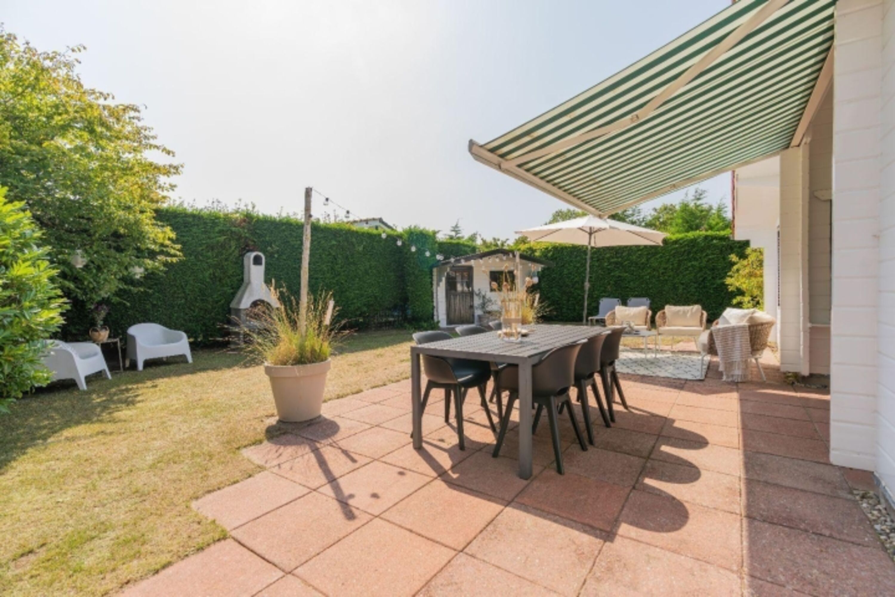 Die sonnige Terrasse mit Gartenmöbel