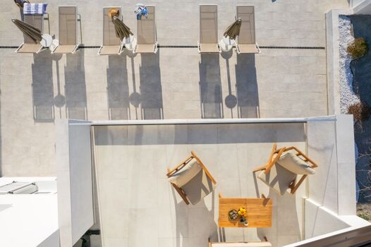 A terrace overlooking the pool and natural surroundings, perfect for morning coffee or evening relaxation.