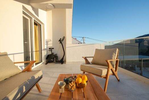 A terrace overlooking the pool and natural surroundings, perfect for morning coffee or evening relaxation.