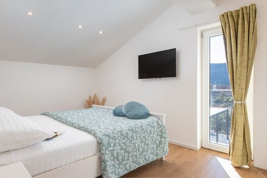 A bedroom withe king-size bed (180x200cm), TV, AC ensure restful nights.