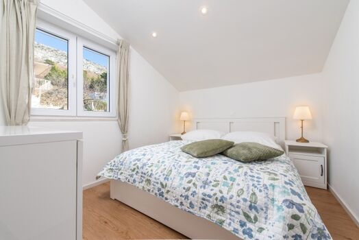 A bedroom with queen-size-bed (160x200cm), TV, A/C ensure restful nights.