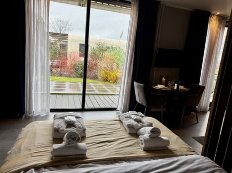 Vom Bett aus hat man einen Blick auf den TV und Garten