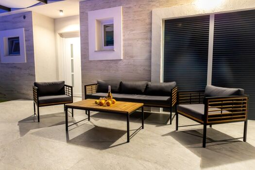 Relaxing by the pool in the evening hours, surrounded by tranquility and soft lighting.