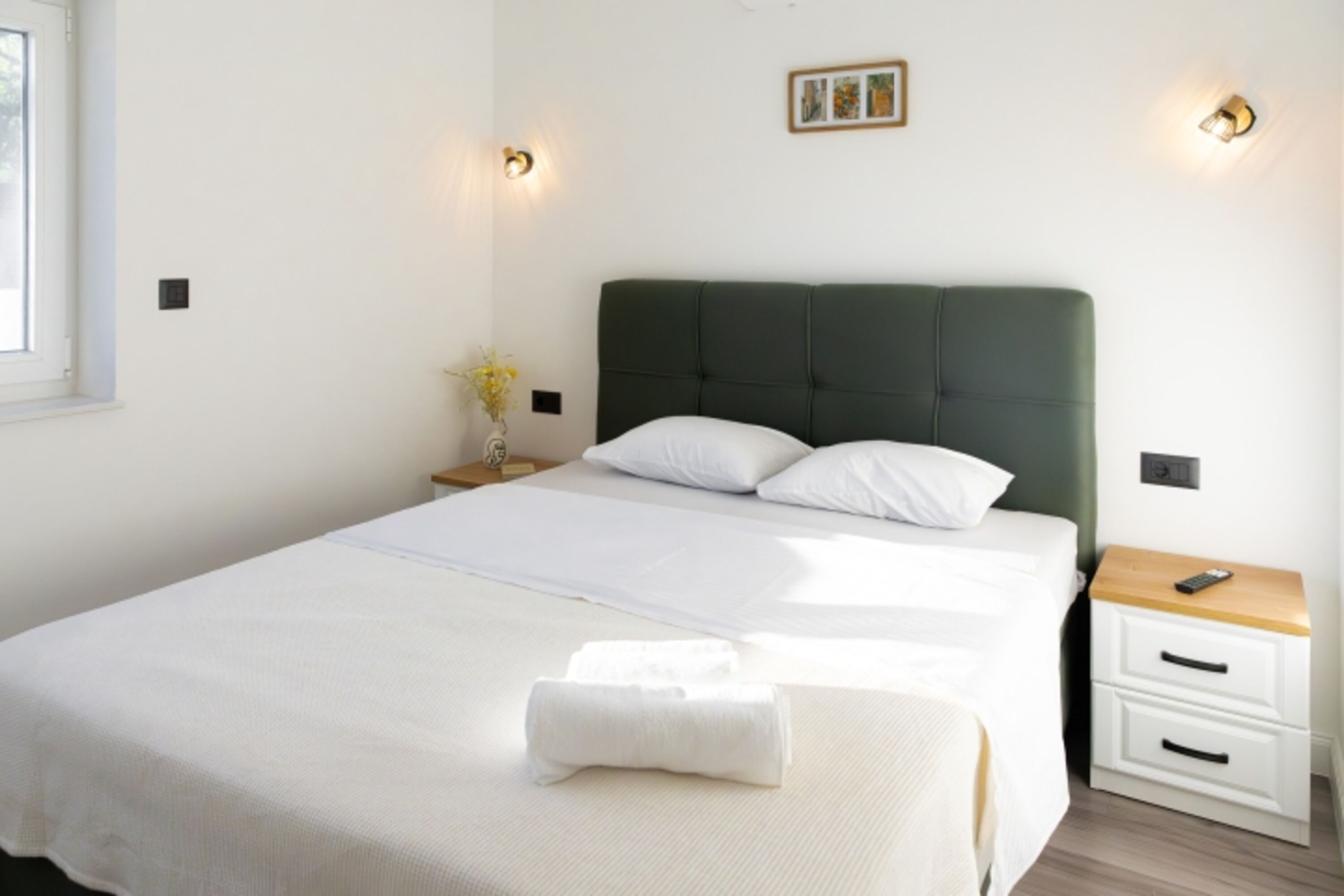A bedroom No. 2 with a queen-size bed, also equipped with air conditioning and a flat-screen TV.