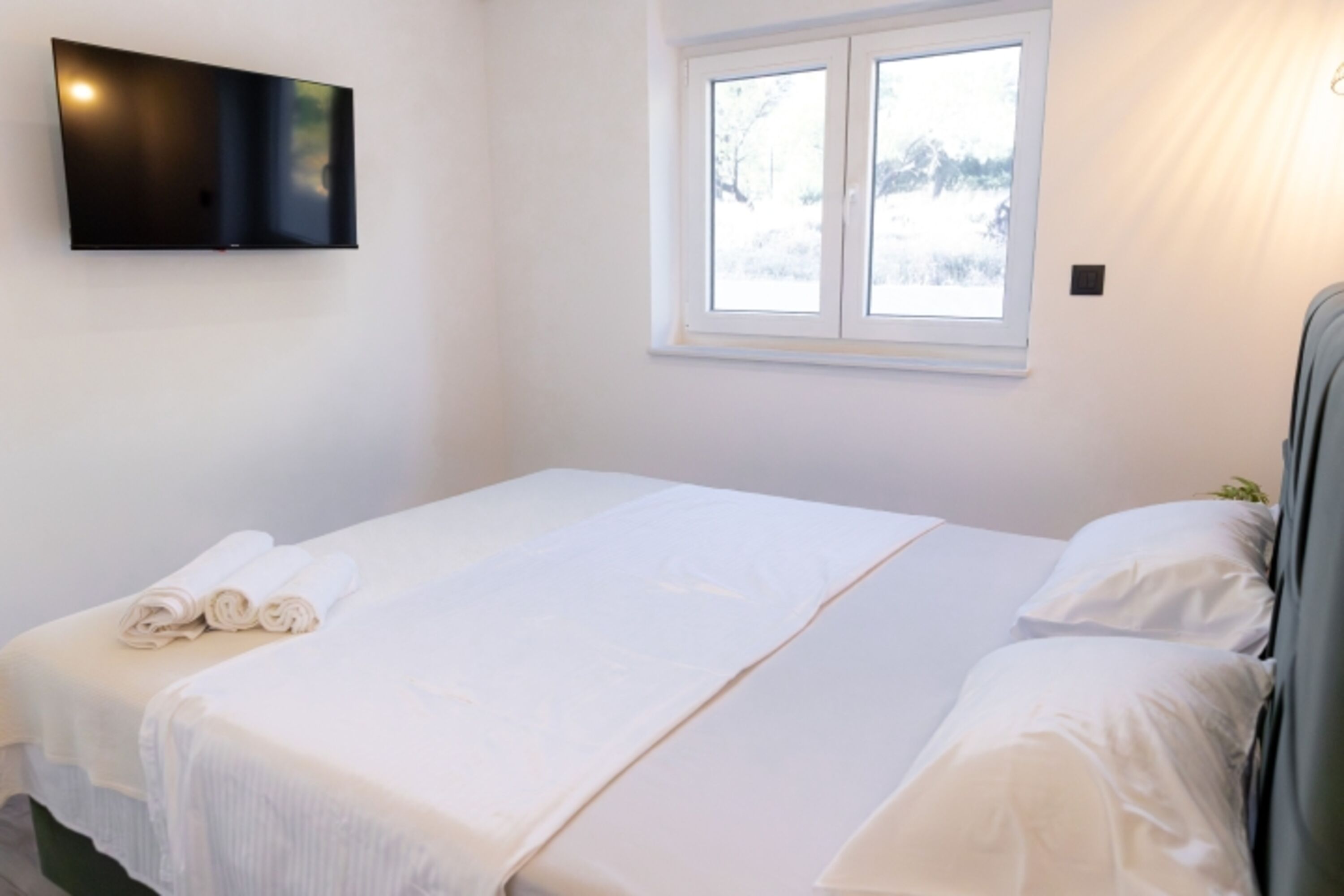 The third bedroom features a queen-size bed and is equipped just like the other two – with air conditioning and a flat-screen TV.