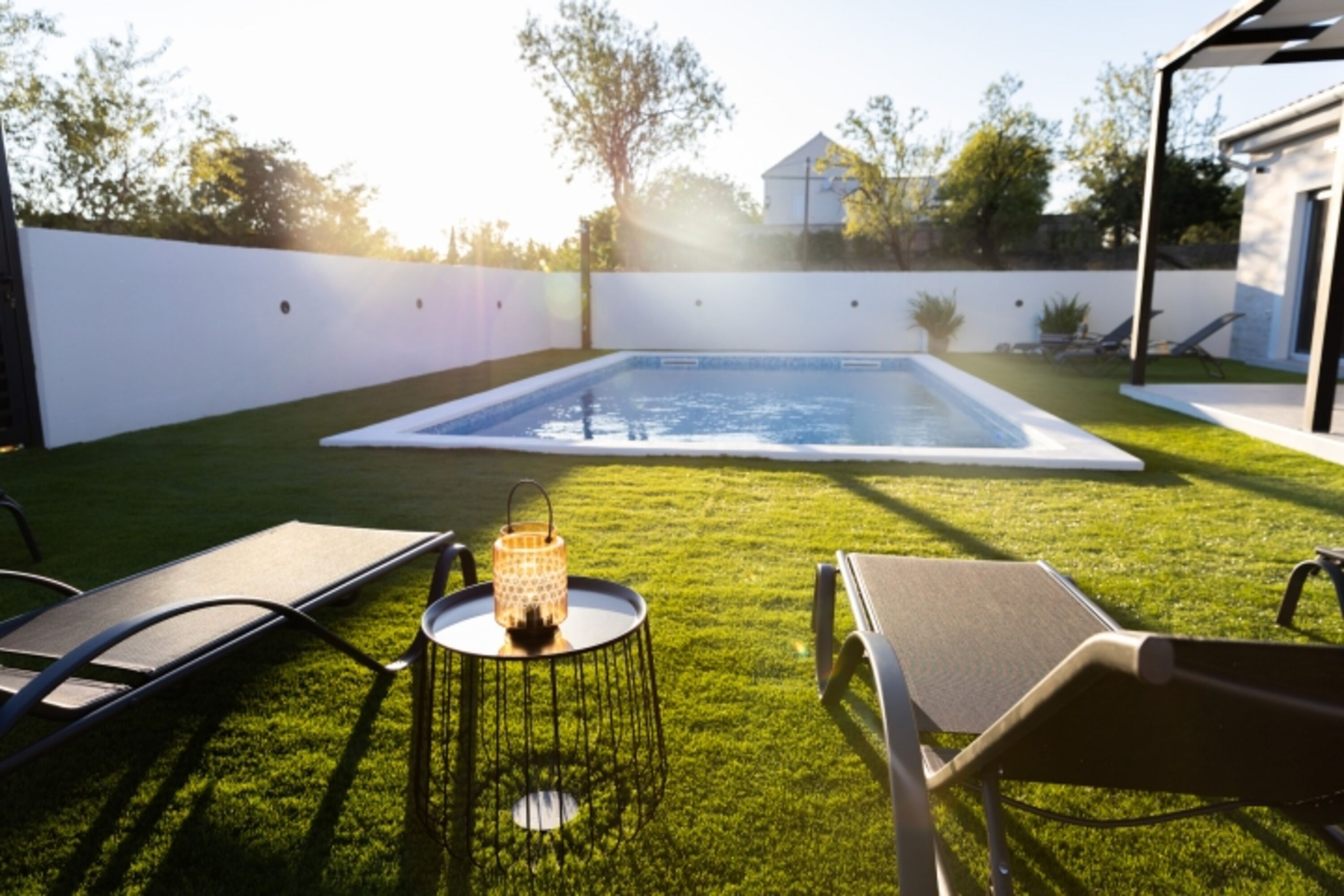 Golden hour by the pool, with the soft chirping of birds in the background.