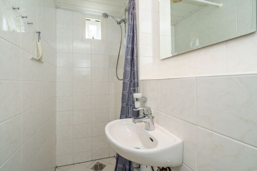 Badezimmer mit Dusche, Waschbecken und Toilette