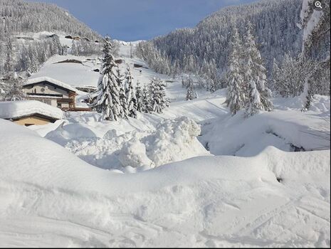 Die direkte winterliche Umgebung des Ferienhauses Mildner in Heiligeblut. Tief verschneite Nachbarhäuser und eine ruhige , authentische Alpenlandschaft inmitten der Großglockner gebiets.