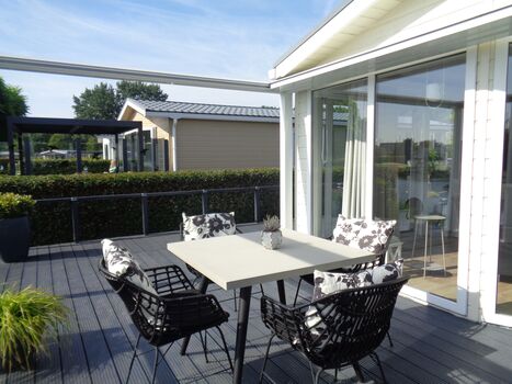 Genießen Sie die Terrasse mit Markise und modernen Möbeln.