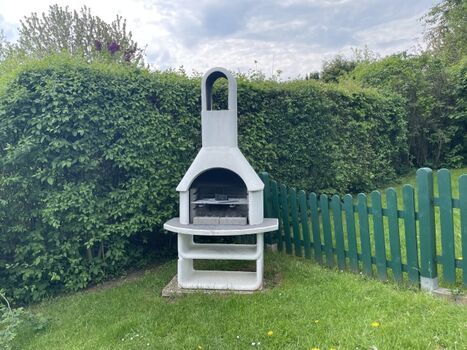 eingezäunter Garten mit Grillkamin