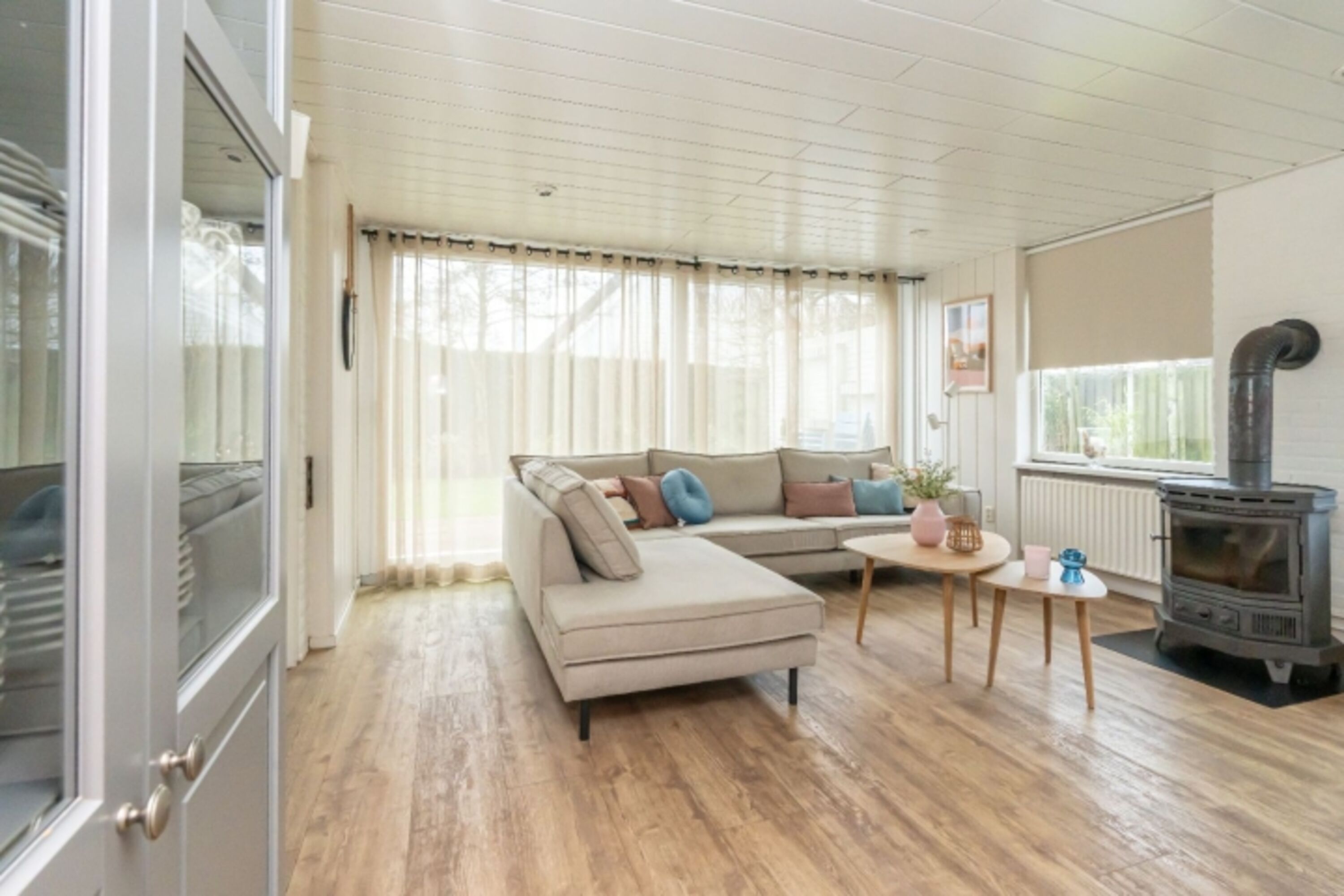 Helles Wohnzimmer mit Sitzecke und Holzkamin