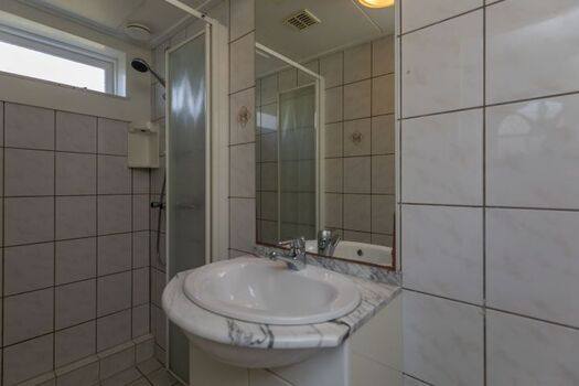 Badezimmer mit Dusche, Waschbecken und Toilette