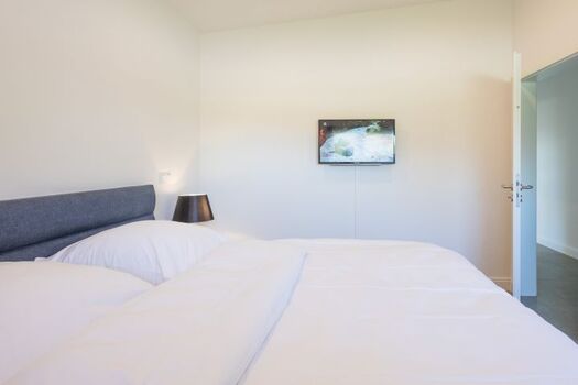 Georgs Huis - Schlafzimmer mit großem Boxspringbett